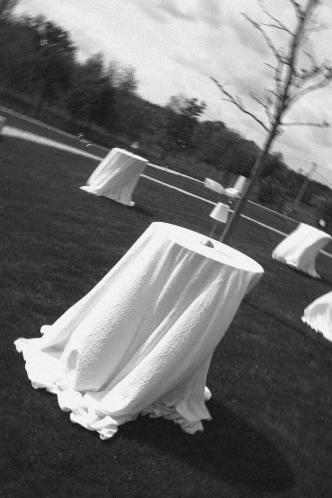 Cocktail tables in white linen on the lawn
