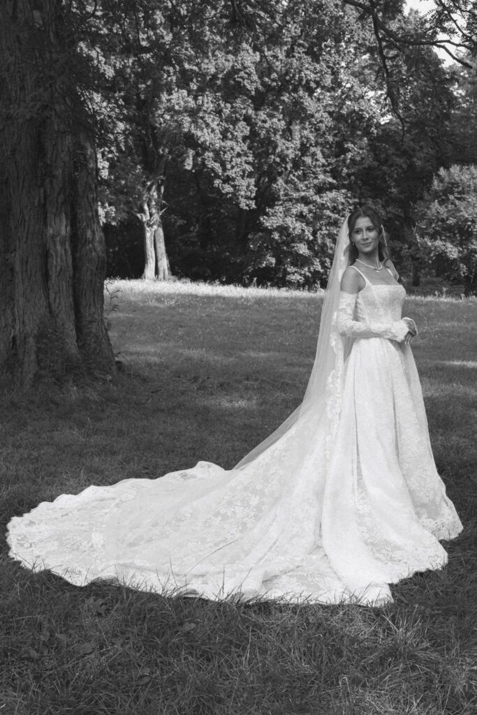 Bride in a gown with a long train in the park
